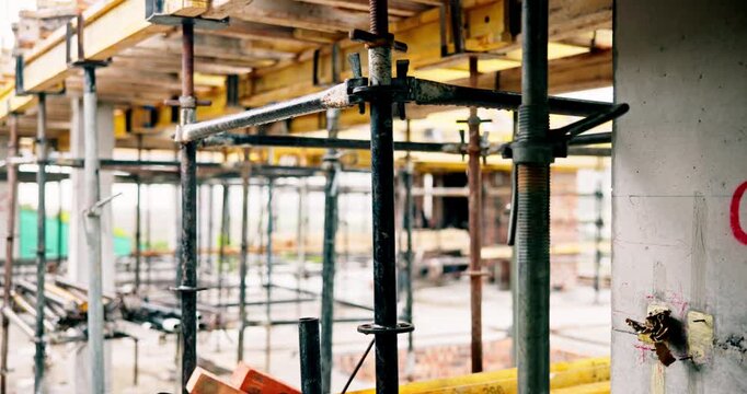 Building, construction or empty site with scaffolding for concrete, renovation or structure support. Metal, exterior framework or upgrade project for house expansion, civil engineering or development