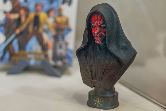 Close-up image of a black and red Darth Moul bust from Star Wars, against a light gray background Two Star Wars books Princess Leia, C-3PO nearby Focused lighti - Kyiv, Ukraine - September 27, 2025