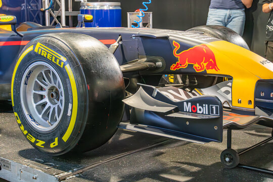 Formula 1 car on display in a museum or exhibition setting, painted in red and blue with sponsor logos Car raised, artificial lighting emphasizing details against a - Kyiv, Ukraine - June 7, 2025