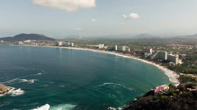 Aerial panorama of Ixtapa Zihuatanejo bay with hotels and coastline in Mexico, drone establishing background, orbit ascend