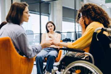 Obraz premium Women supporting crying friend in wheelchair during mental health group therapy session