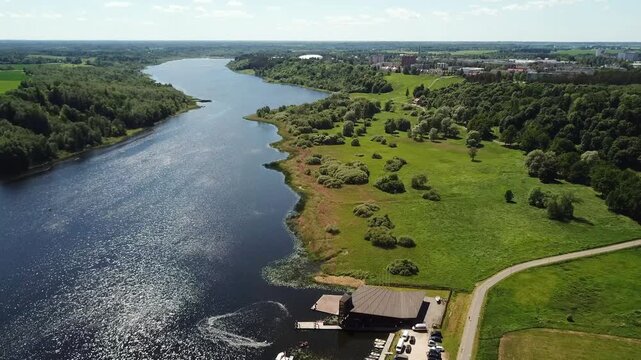 Spectacular aerial view of jet skis creating a perfect heart shape pattern with water wakes on the scenic Viljandi lake during summer.