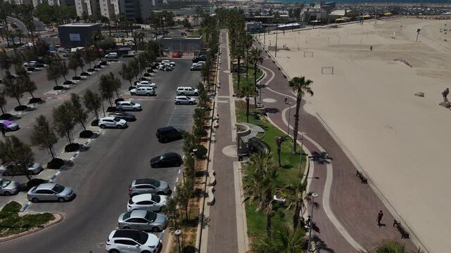 4K Drone Forward Flight Over HaKeshet Beach in Ashdod, Israel, Slow Motion Coastal Reveal with Mediterranean Sea and City