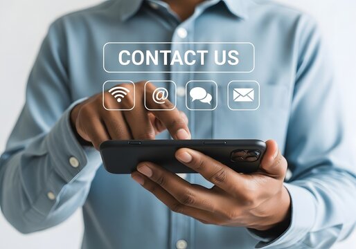 Professional businessman in a light blue shirt using a smartphone to access contact options like email, phone, and social media icons for customer support