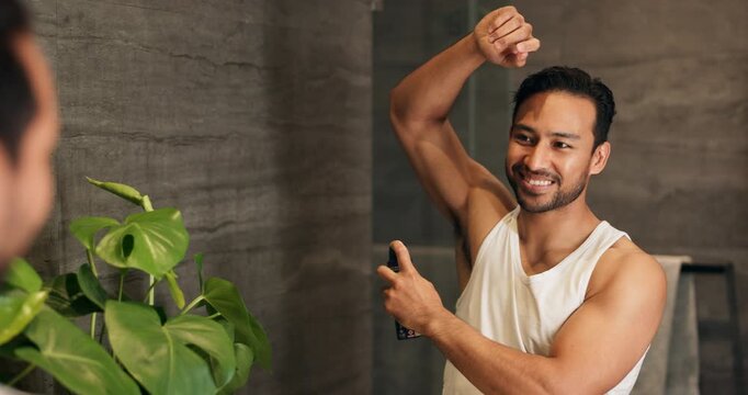 Happy, mirror and man in bathroom with deodorant, antiperspirant and grooming. Home, smile and person in reflection with spray, perfume and fragrance for odor control, hygiene or underarm protection