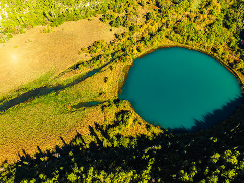 Aerial view of the confluence where the Cikola river lake drom torak view tributary joins the Krka river canyon, Krka National Park, Dalmatia, Croatia.