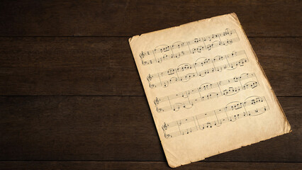 Naklejka premium Classical music manuscript with flowing notes on aged paper.