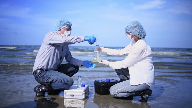 Scientist annalist wearing protective uniform, mask ,glove and under working water analysis effected from phytoplankton at sea analyst case in laboratory is environment pollution problem concept.