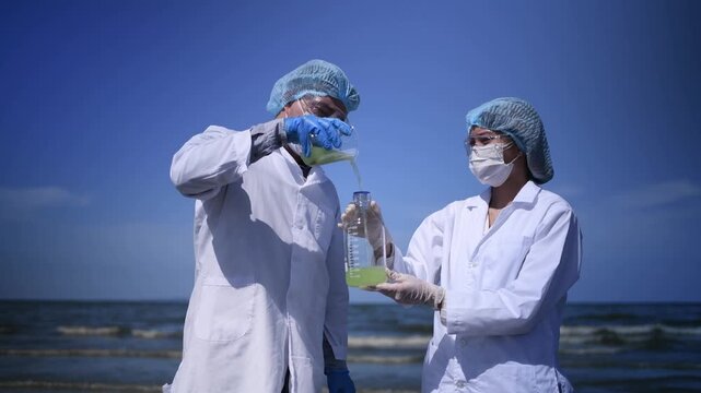 Scientist annalist wearing protective uniform, mask ,glove and under working water analysis effected from phytoplankton at sea analyst case in laboratory is environment pollution problem concept.