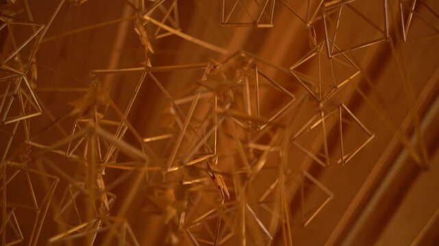 Art installation decoration with wire geometric figures hanging from ceiling.