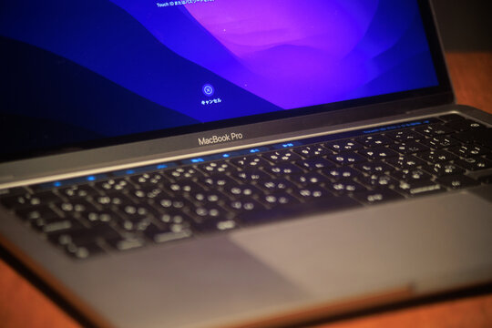 Fukuoka, Fukuoka Japan - 2022 08 07: An Apple MacBook Pro laptop computer displaying a login screen with the backlit keyboard illuminated.