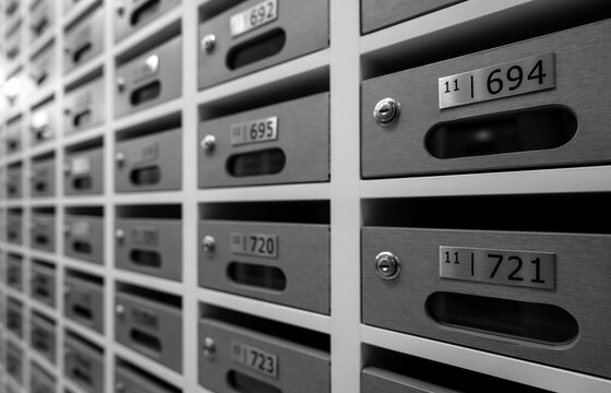 Modern mail box of apartment filled home numbers of resident. Mailbox in a row in letter box office of apartment. Post office and envelope mail delivery business concept. Postbox lock for security.