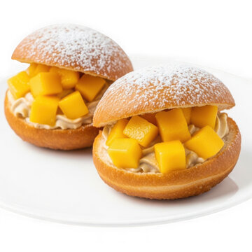 Two powdered sugar cream puffs with fruit filling