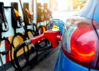 Car fueling at gas station. Refuel fill up with petrol gasoline. Petrol pump filling fuel nozzle in fuel tank of car at gas station. Petrol industry and service. Petrol price and oil crisis concept. © Fahroni