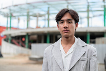 Obraz premium Portrait of non-binary Thai Isan contractor at construction site