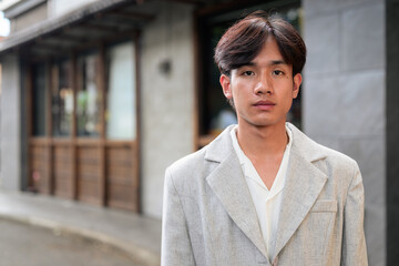 Obraz premium Portrait of non-binary Thai Isan professional standing on street