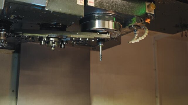 CNC tool changer carousel rotates inside a machining center, showing automatic tool change, industrial automation, milling equipment, precision manufacturing and factory workshop technology.