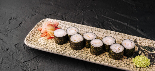 Shrimp maki sushi rolls on decorative plate with wasabi and ginger © AntAlexStudio