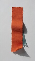Obraz premium Torn terracotta orange paper strip with deckle edges and teal ribbon on grey background for scrapbooking layout and stationery mockup with generous copy space