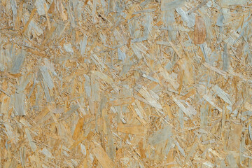 Obraz premium A close-up of the texture of a beige pressed sawdust panel.