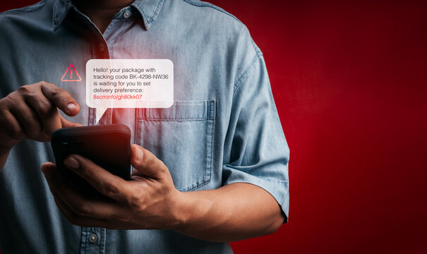 Person receiving fake delivery SMS with phishing tracking link on smartphone. Cyber scam, smishing attack, mobile fraud, fake package notification, identity theft, and online security risk concept.