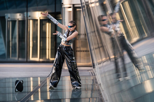Futuristic dancer posing in a modern city street