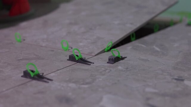 Tile leveling clips during large format floor tile installation