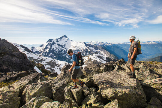 Two hikers navigate a rocky alpine ridgeline