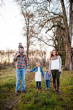 Beautiful young family of five posing outdoors