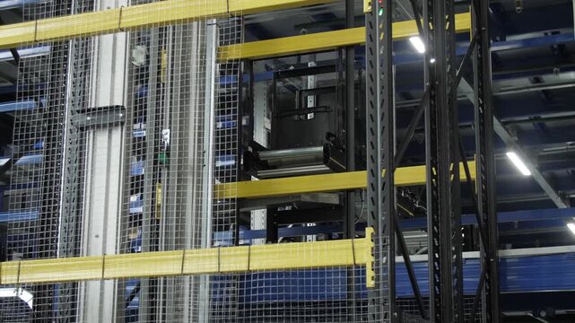 Automated warehouse system with computer controlled lifting transport devices.