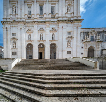 Sao Vicente de Fora Church facade featuring a monumental staircase leading to its ornate entrance with statues, representing historic Portuguese architecture and religious heritage in Lisbon