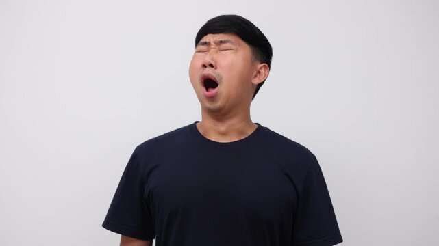 Asian man yawn and feeling sleepy isolated