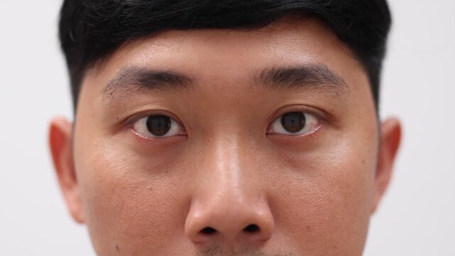 Close up man eye black color,Detail face and eye of asian man