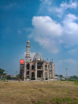 Islamic mosque under construction against bright blue sky at Nurul Amal Mosque Sumur Welut Surabaya Indonesia