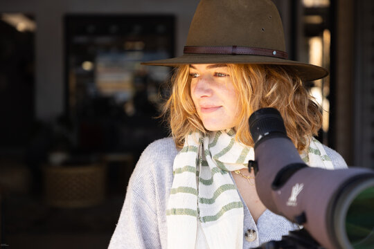 young stylish woman wearing hat with telescope, Stanford, South Africa
