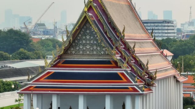 The ornate roofs of The Grand Palace in Bangkok, Thailand, showcase traditional Thai architecture with vibrant colors and intricate details, a significant cultural landmark.