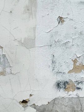 Texture of very old cracked and peeling paint on a concrete wall