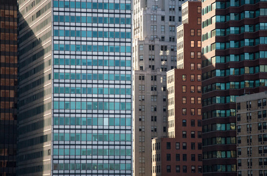 Skyscrapers and modern office buildings rise above the city, representing a vibrant architectural destination for business and global tourism in Lower Manhattan, New York City.
