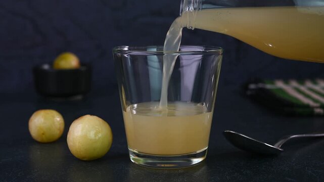 Serving amla juice in a cup.
