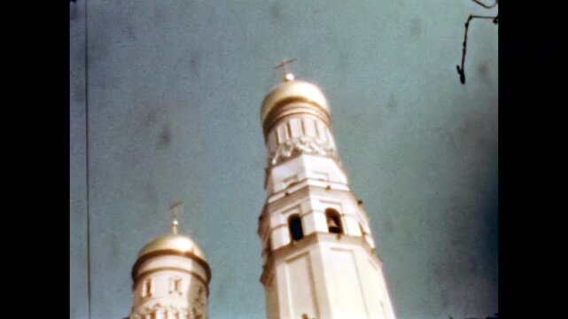 Gleaming golden church domes, ivan great bell tower of assumption cathedral within the moscow kremlin against a clear blue sky. Old film. Archival retro. Vintage archive. 1960s Moscow Russia USSR