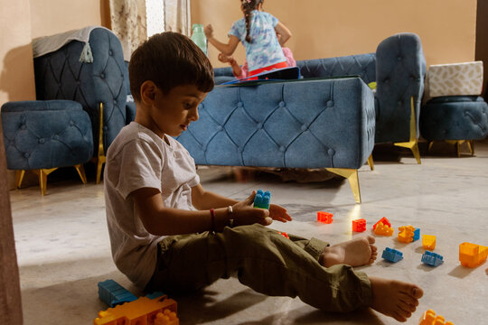Boy sitting on floor playing with blocks
