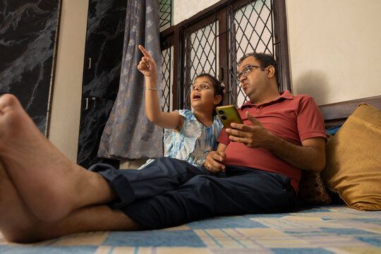 girl showing her father something with excitement