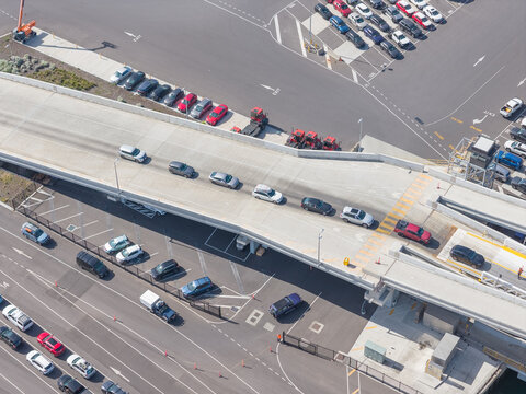 Aerial view of cars driving up a boarding ramp