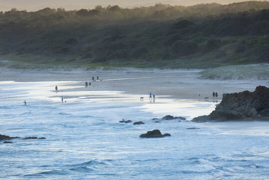 Late afternoon summer beach walking
