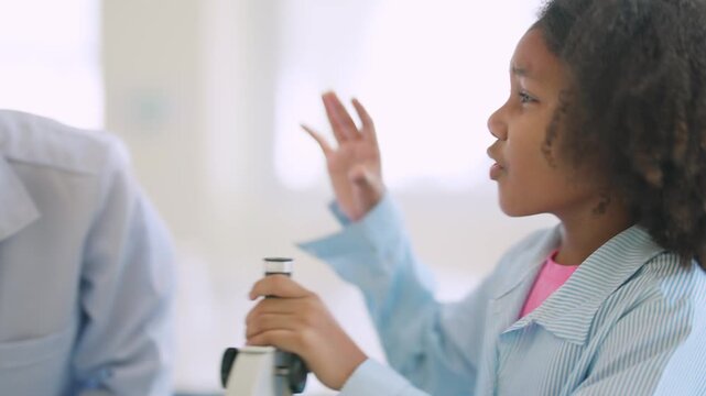 Young Scientist's Discovery: A curious young girl in a lab coat leans over a microscope, her hand raised in a gesture of wonder and intellectual pursuit.