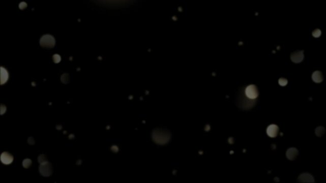 Golden light rays shining through dark background with sparkling particles and glittering specks