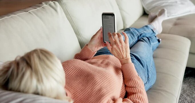 Relax, typing and old woman on sofa, phone screen and how it works for digital app. Pensioner, apartment and mature person in home, online reading for website instructions and review for technology