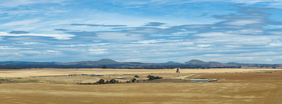 Aerial panorama view of lenticular clouds over expansive dry farmland