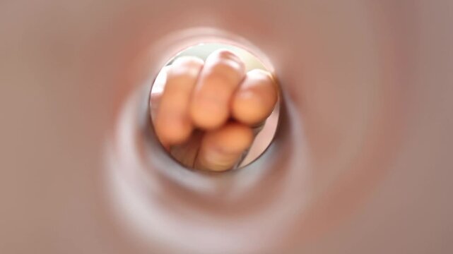 Point of view from inside a chip tube as a snack lover peers inside trying to reach the last chips highlighting food cravings temptation and eating habitsvertical 