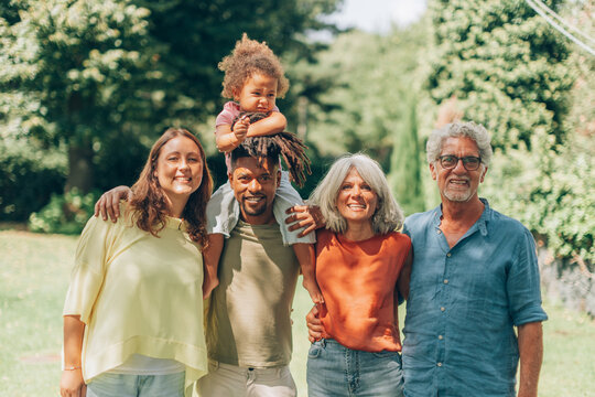 Happy multicultural family posing outdoors showing unity and togetherness
